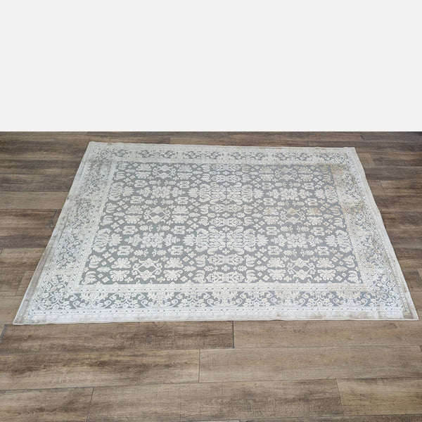 1. Rectangular Jaipur rug with a high-low damask-inspired pattern in light and dark tones on a wood floor.