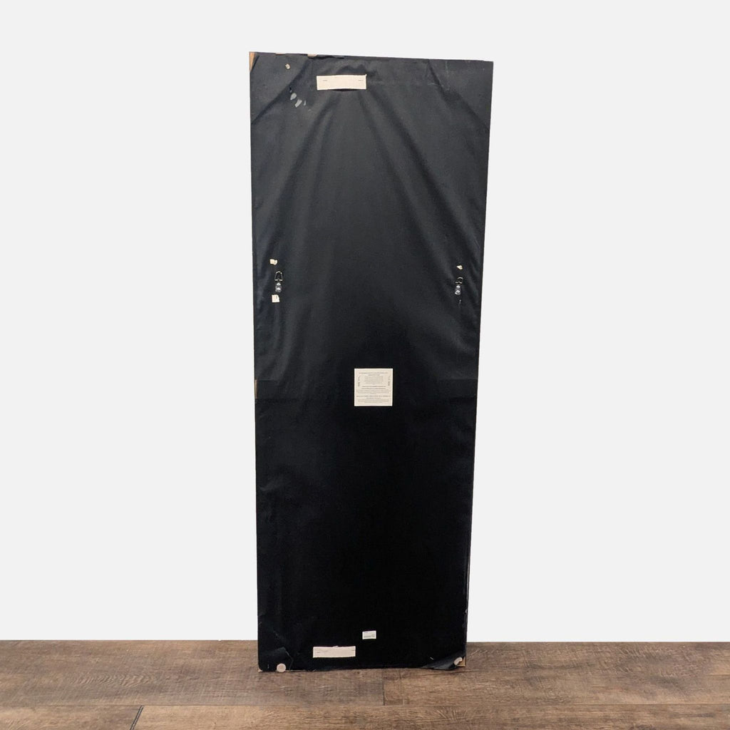 2. Backside of a rectangular Target mirror, black covering with hanging hardware and labels visible.  