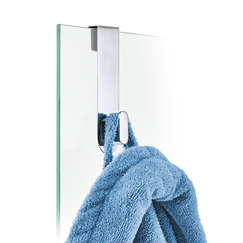 3. 2Modern chrome hook on a glass door, holding a blue towel, designed for modern bathroom organization.