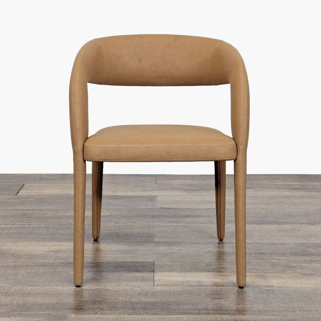 1. Front view of a Restoration Hardware dining chair with a curved backrest and tan vegan leather upholstery.  