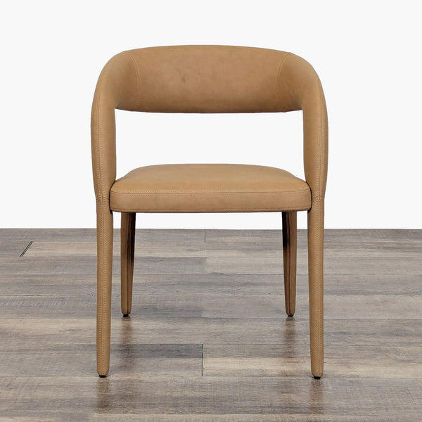 1. Front view of a Restoration Hardware dining chair with a curved backrest and tan vegan leather upholstery.  