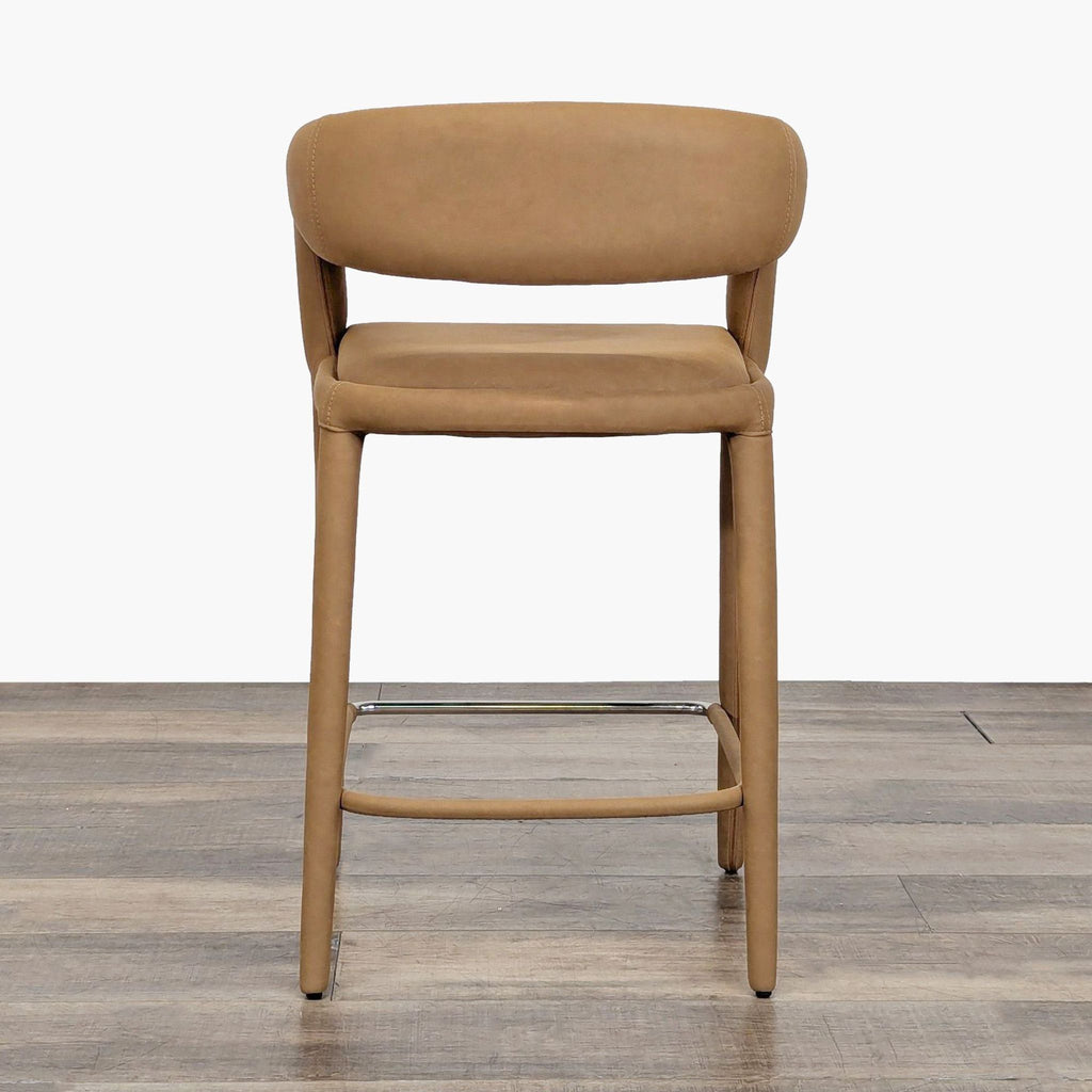 2. Front view of a Restoration Hardware stool with padded seat, barrel backrest, and fully wrapped vegan leather.