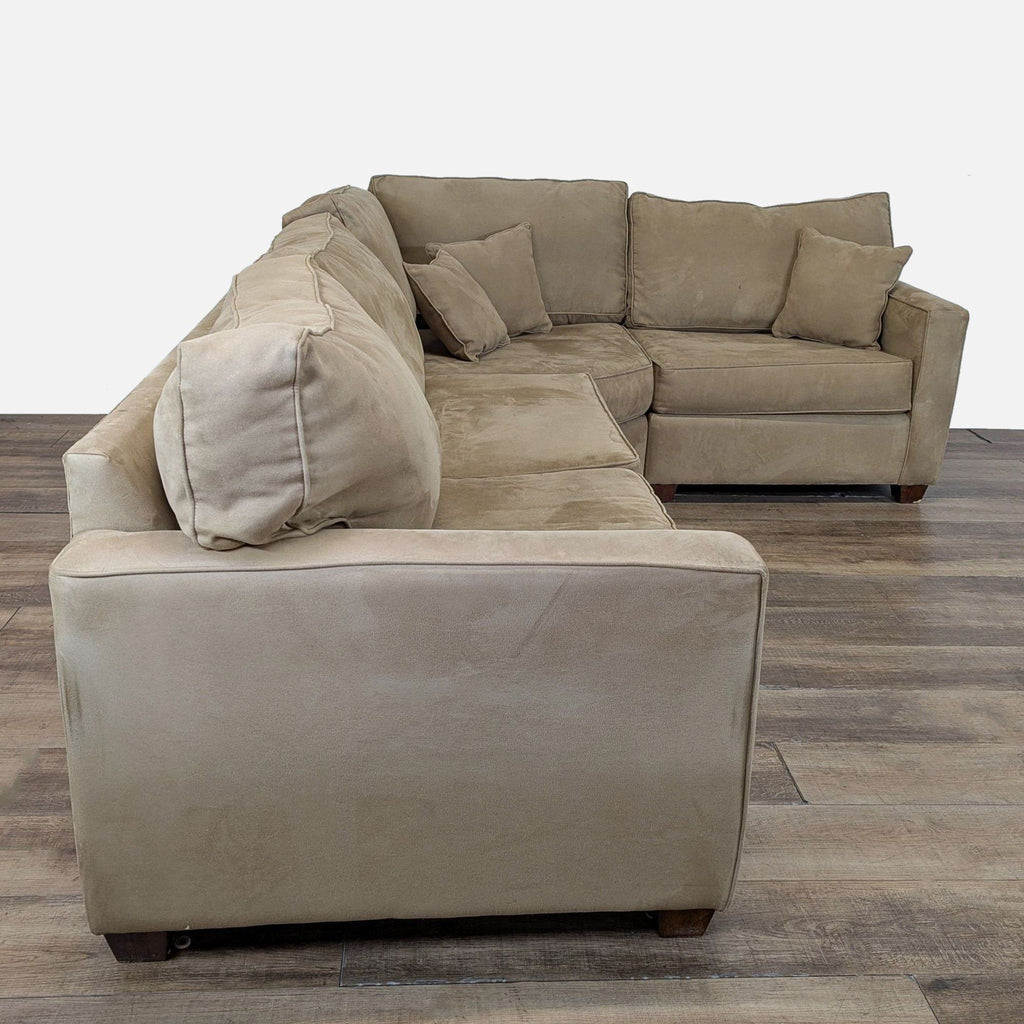 2. Side angle of a Reperch transitional microfiber sofa with track arms and loose back cushions.  