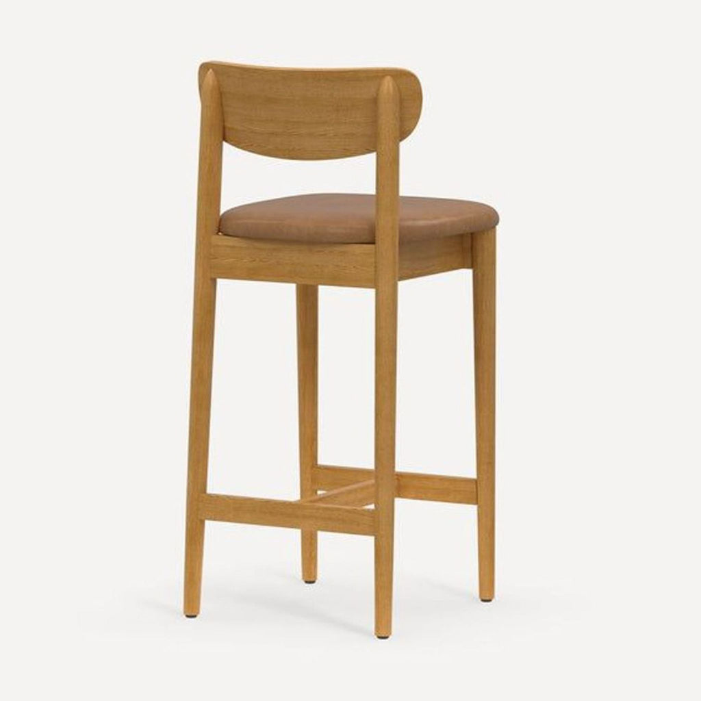 Side view of a Burrow stool featuring a hardwood frame and a cushioned, upholstered seat.  