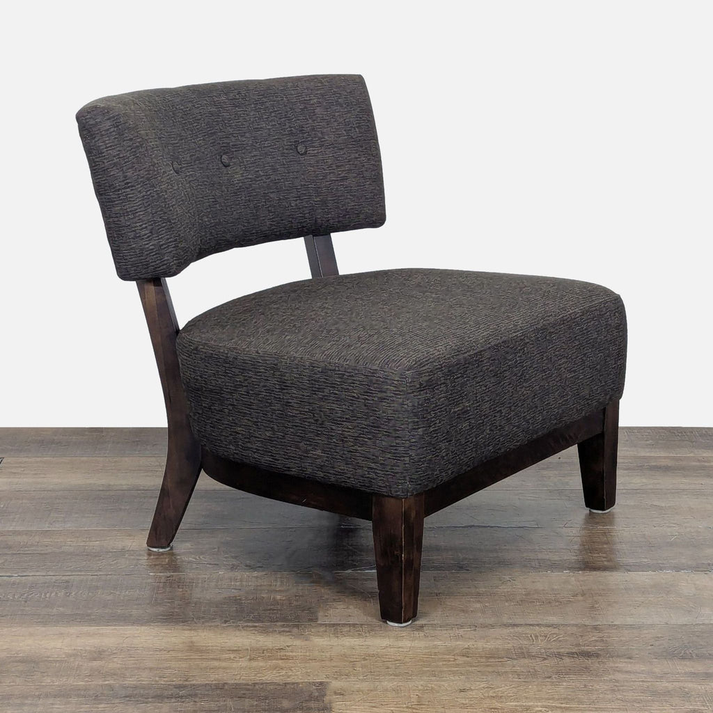 3. Angled view of a Reperch slipper chair with wooden legs and a tufted, upholstered seat and backrest.