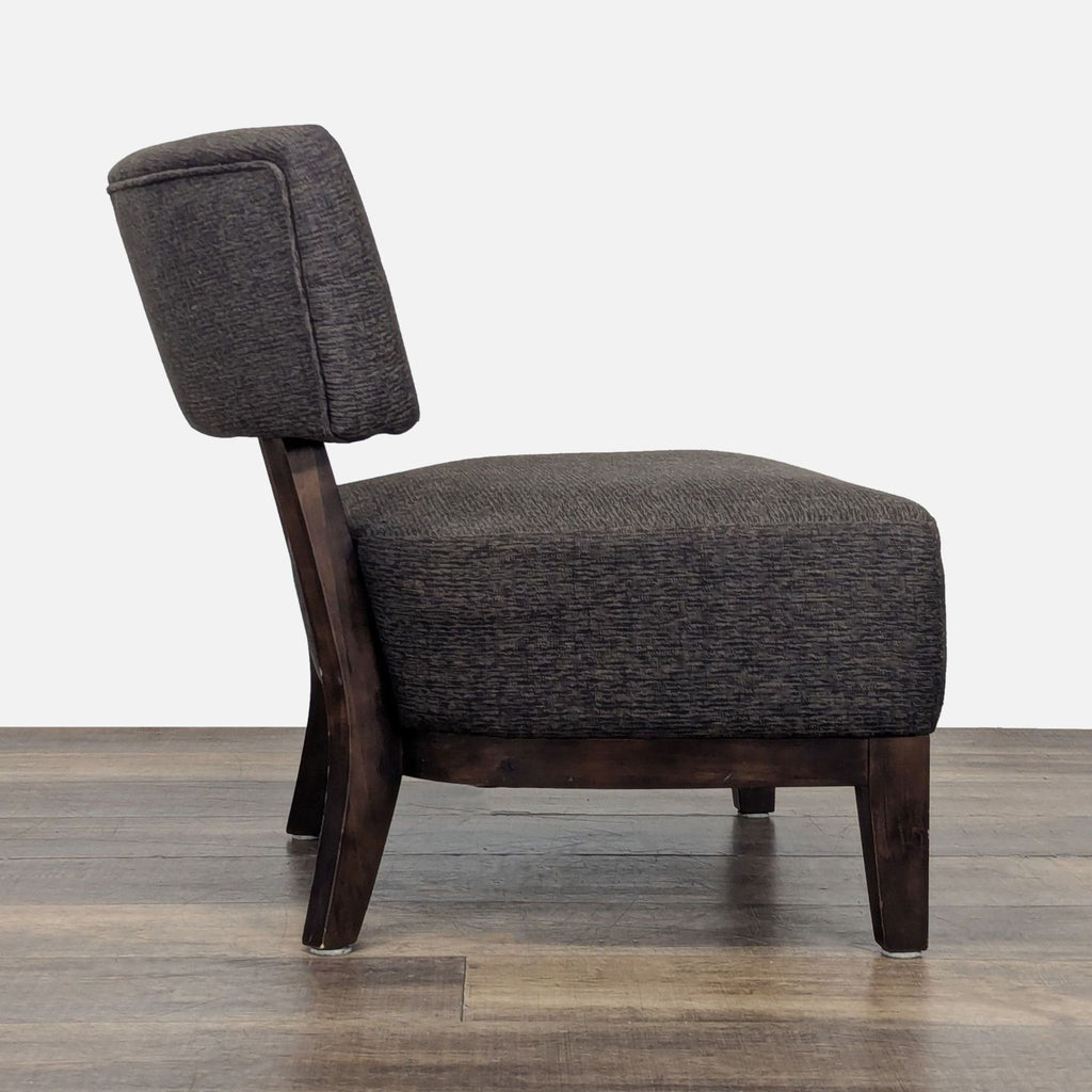 2. Side profile of a lounge chair by Reperch, featuring a wood frame and padded button-tufted upholstery.