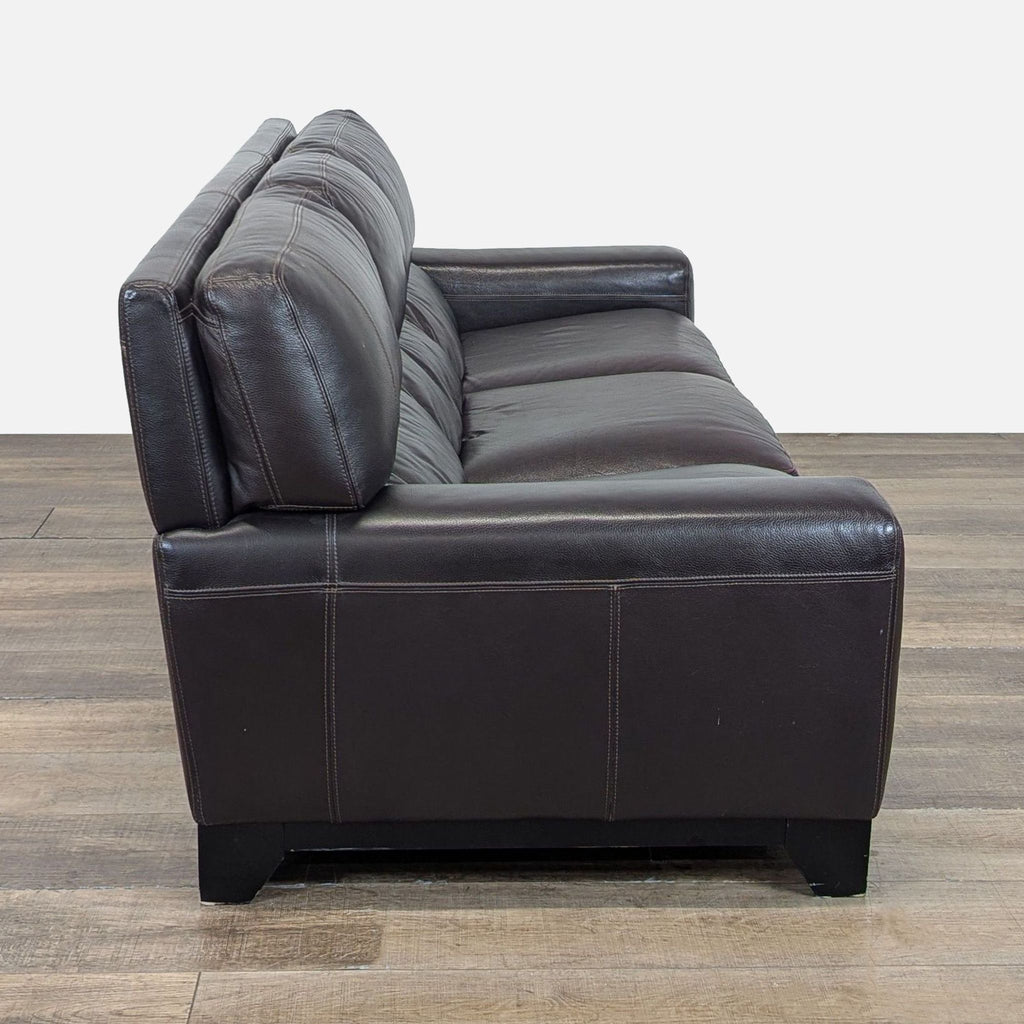 2. Side angle of the Reperch 3-seat sofa showing stitching details on dark brown leather upholstery.