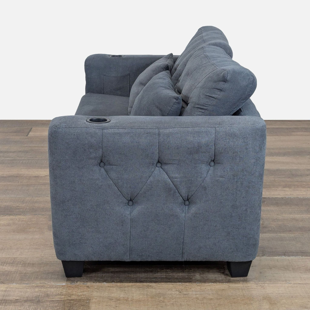 3. Side view of Wade Logan sleeper sofa, showing armrest cup holder and tufted detailing on the fabric upholstery.