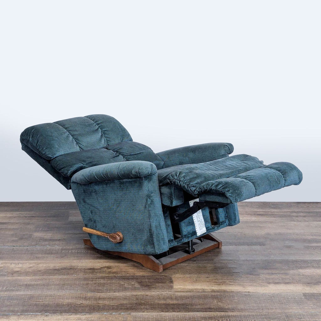 2. La-Z-Boy recliner in blue fabric, shown fully reclined with extended footrest on a wood floor.