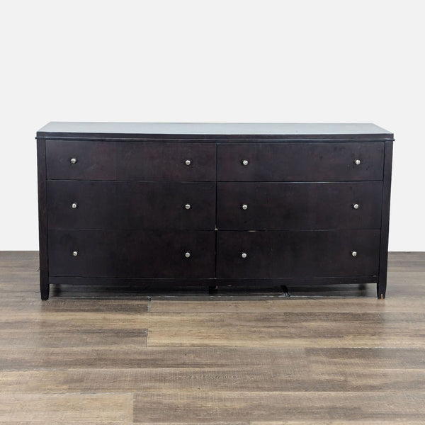1. Crate and Barrel dresser with a bowed front and 6 drawers on metal glides, shown on wood flooring.  