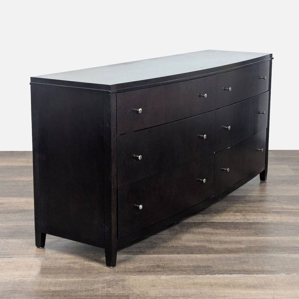 3. Side view of Reperch dresser, featuring a bowed front and six drawers on sleek metal glides.