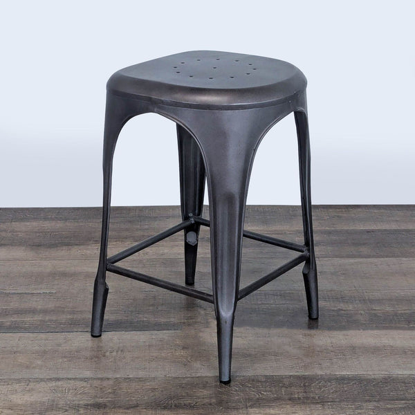 1. Industrial-style black metal stool from Restoration Hardware, featuring a triangular seat and minimalist design.