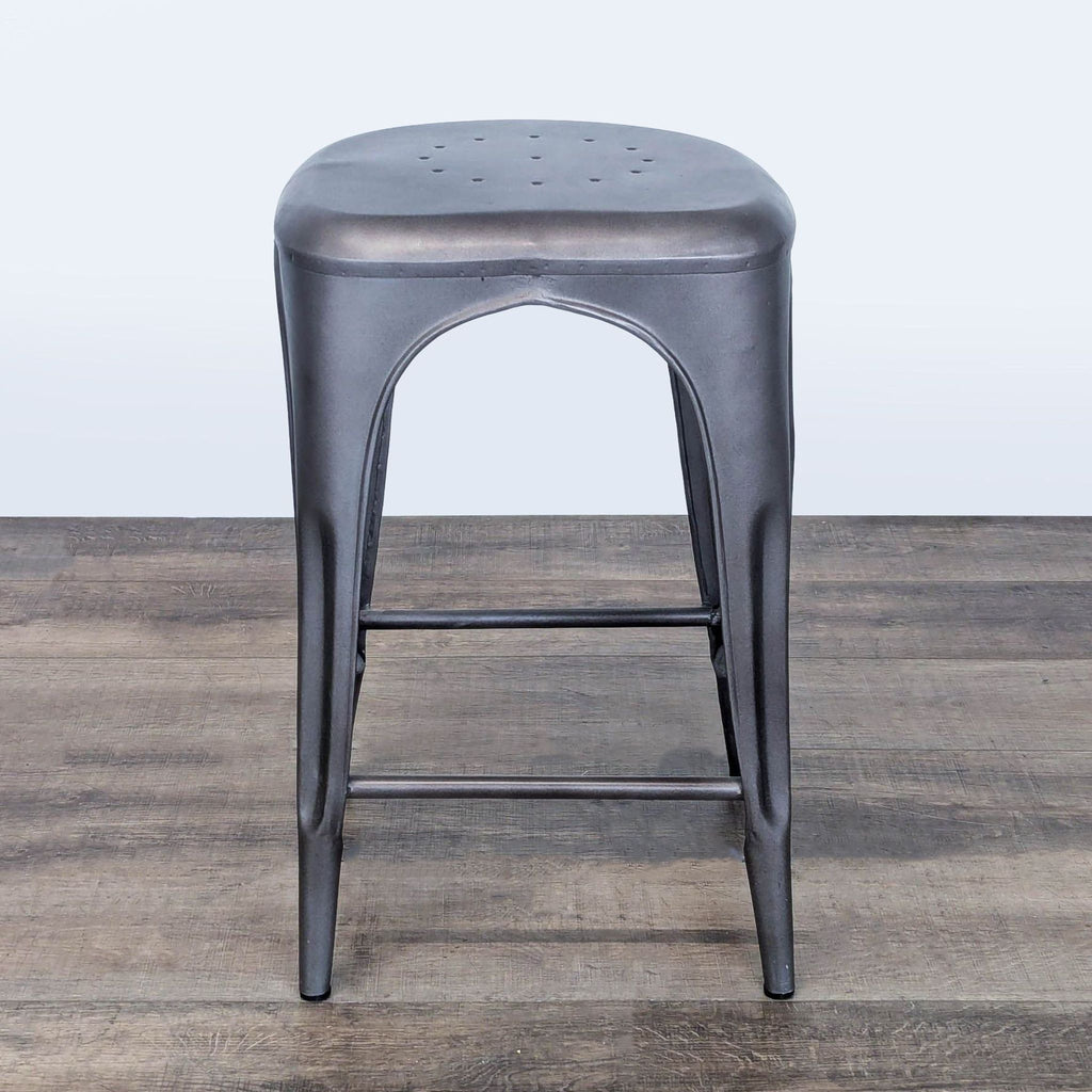 3. Black metal Restoration Hardware stool with a compact form, suitable for both seating and decorative purposes.