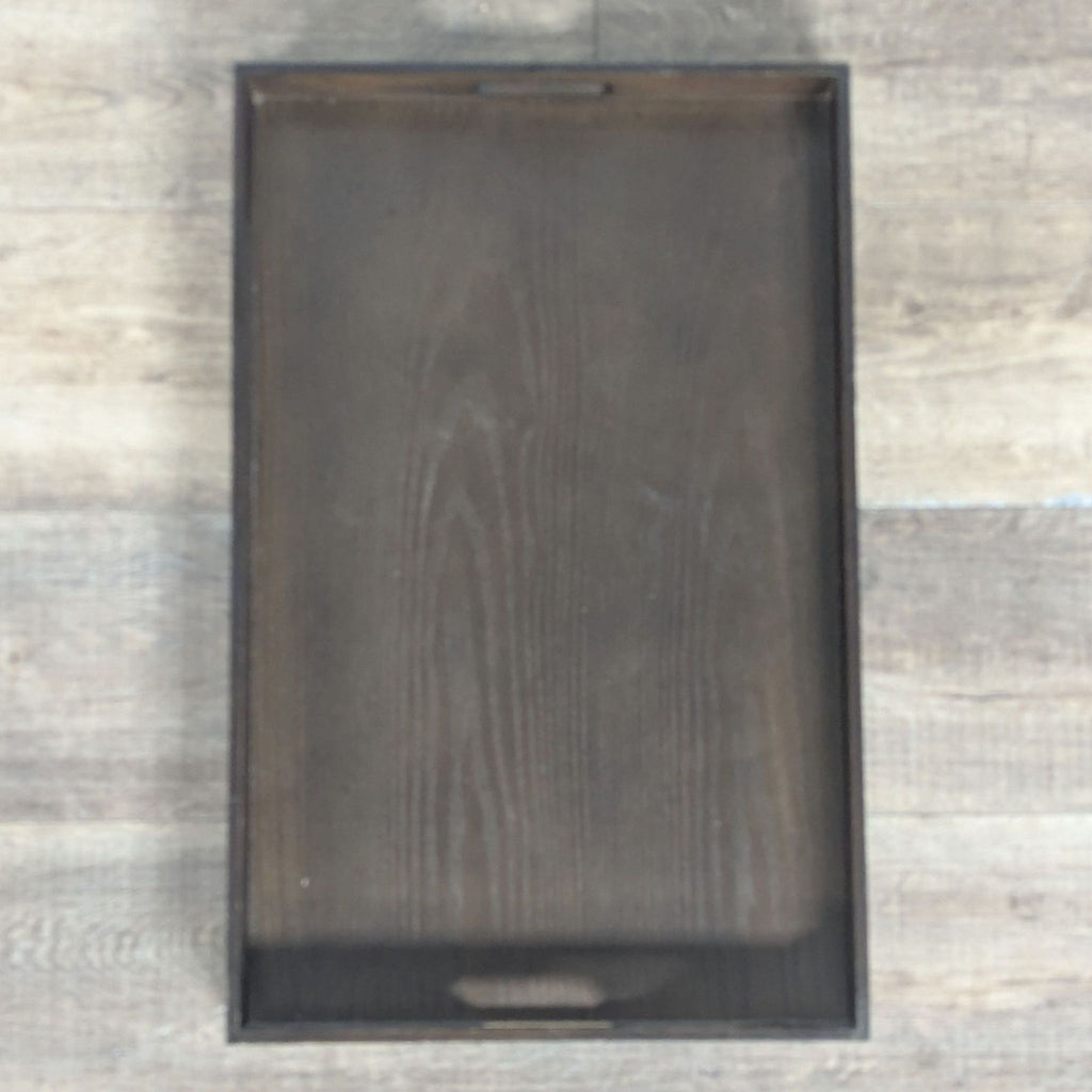 2. Top-down view of a rectangular West Elm dark wood tray with visible wood grain and integrated side handles.