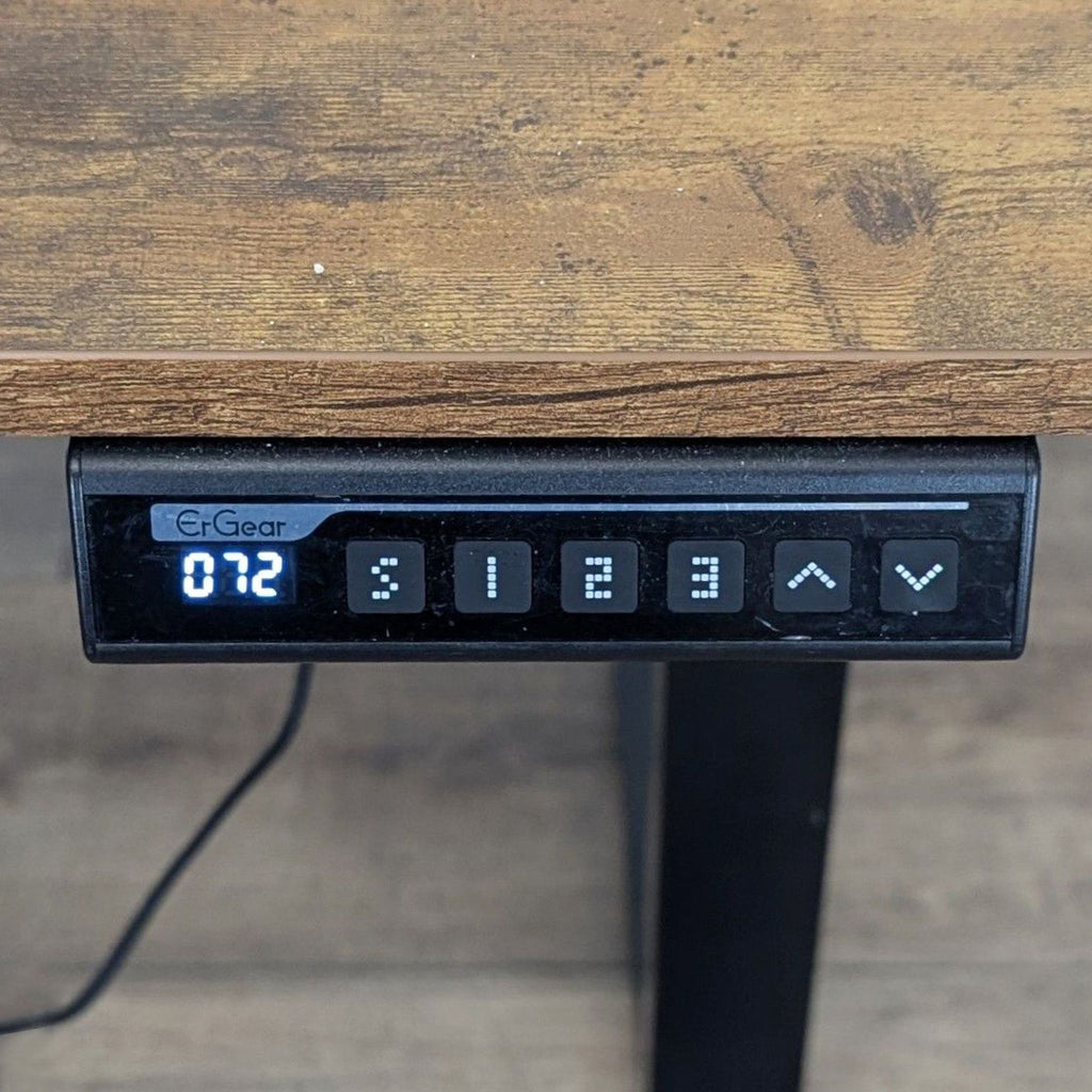 Closeup of the programmable controller on a Bestqi Innovation desk, showing digital display and adjustment buttons.