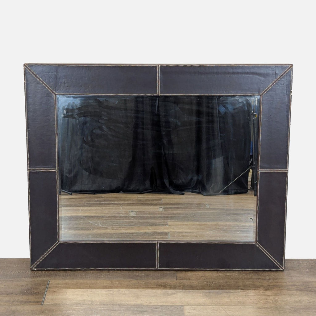 1. Rectangular Reperch mirror with wide dark leather frame and visible stitching, placed on a wood floor.