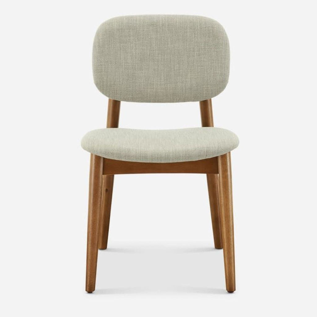2. Castlery dining chair front view, featuring bent wood seat and back with light fabric upholstery and rubber wood legs.
