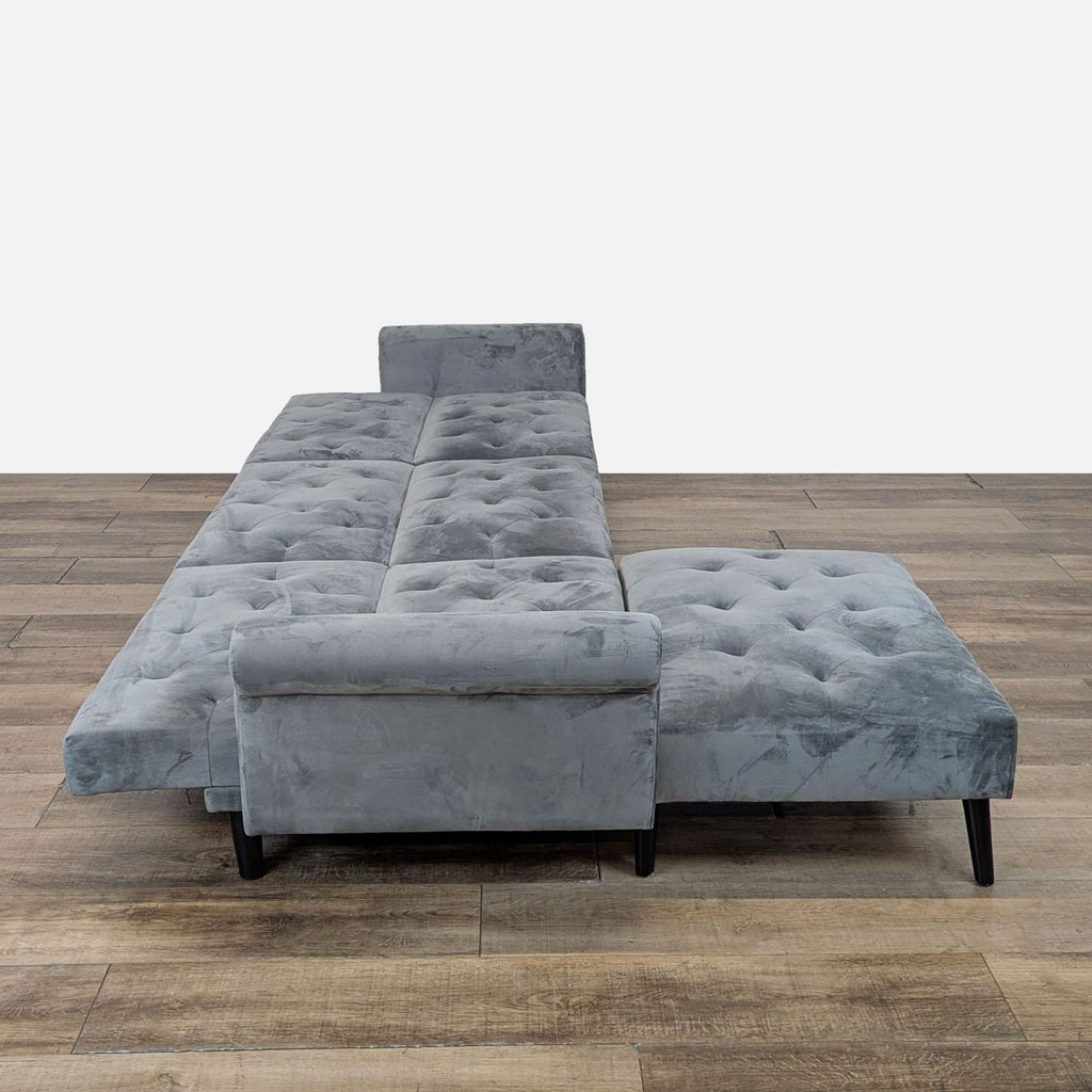 2. Gray fabric Reperch sofa shown converted to a sleeper with tufted cushions and moveable ottoman attached.  