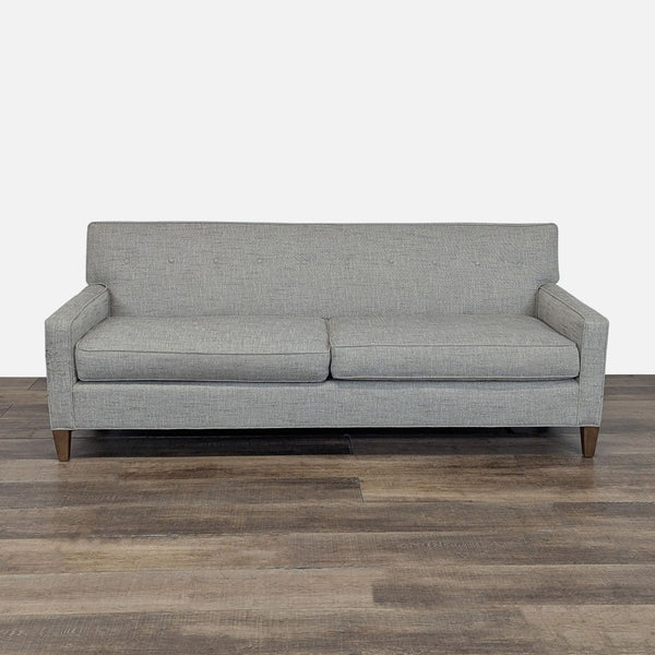 1. Front view of a Mitchell Gold + Bob Williams 3-seat sofa with button tufting, slim arms, and tapered wood legs.