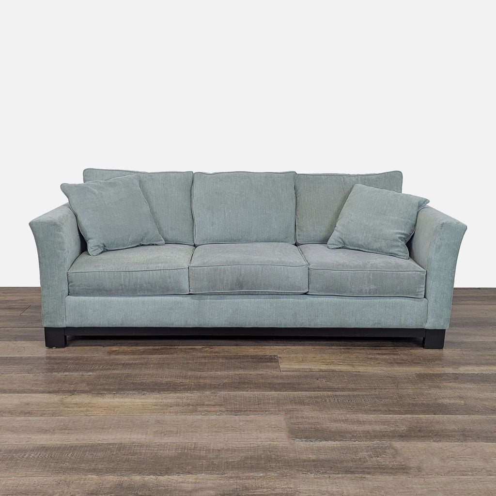 1. Reperch 3-seat sofa with gently flared arms, loose cushions, and a dark wood base, front view.