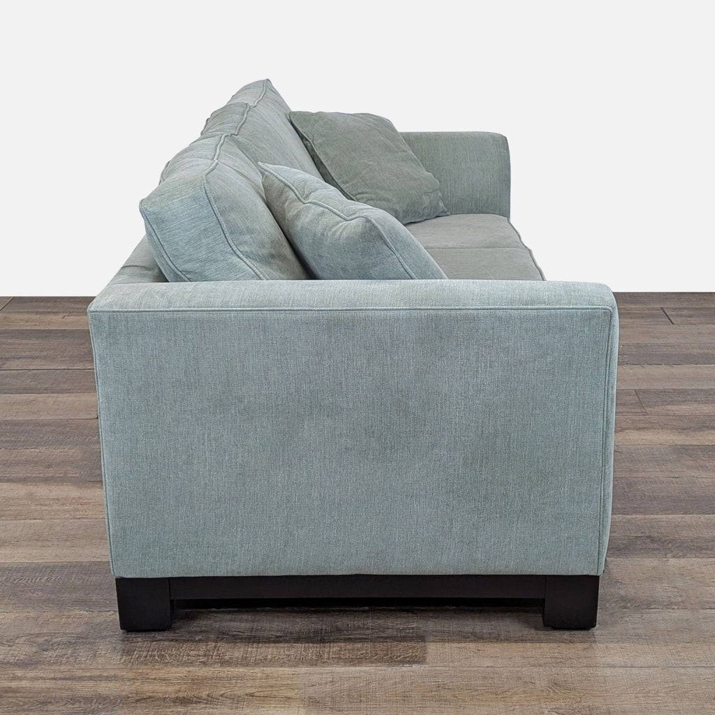 2. Side profile of a Reperch 3-seat sofa showing the flared arm and plush loose cushions.