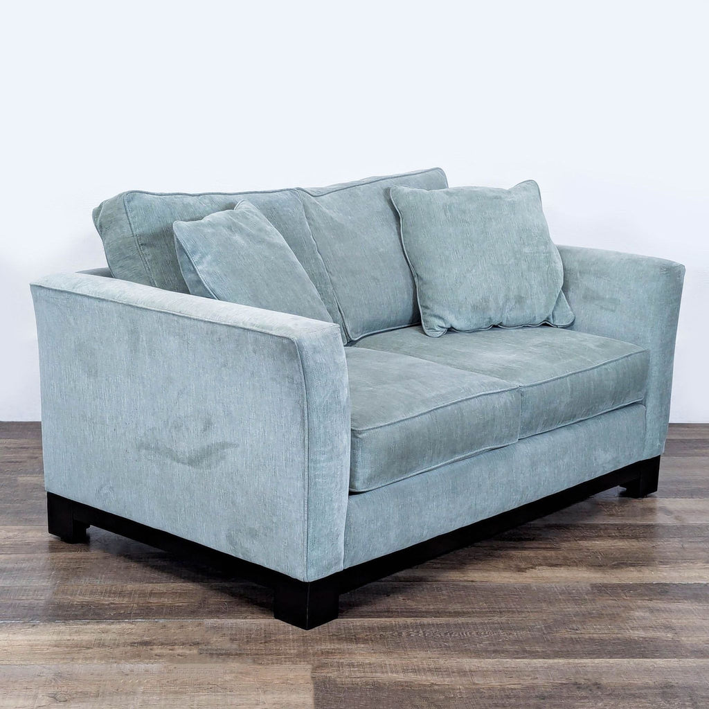 3. Angled view of Jonathan Louis loveseat with loose cushions, gently flared arms, and a dark wood base.