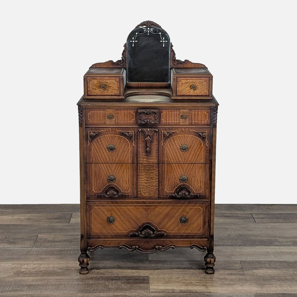 Ornate Reperch dresser with carved details, multiple drawers, and a small mirror, shown from the front.