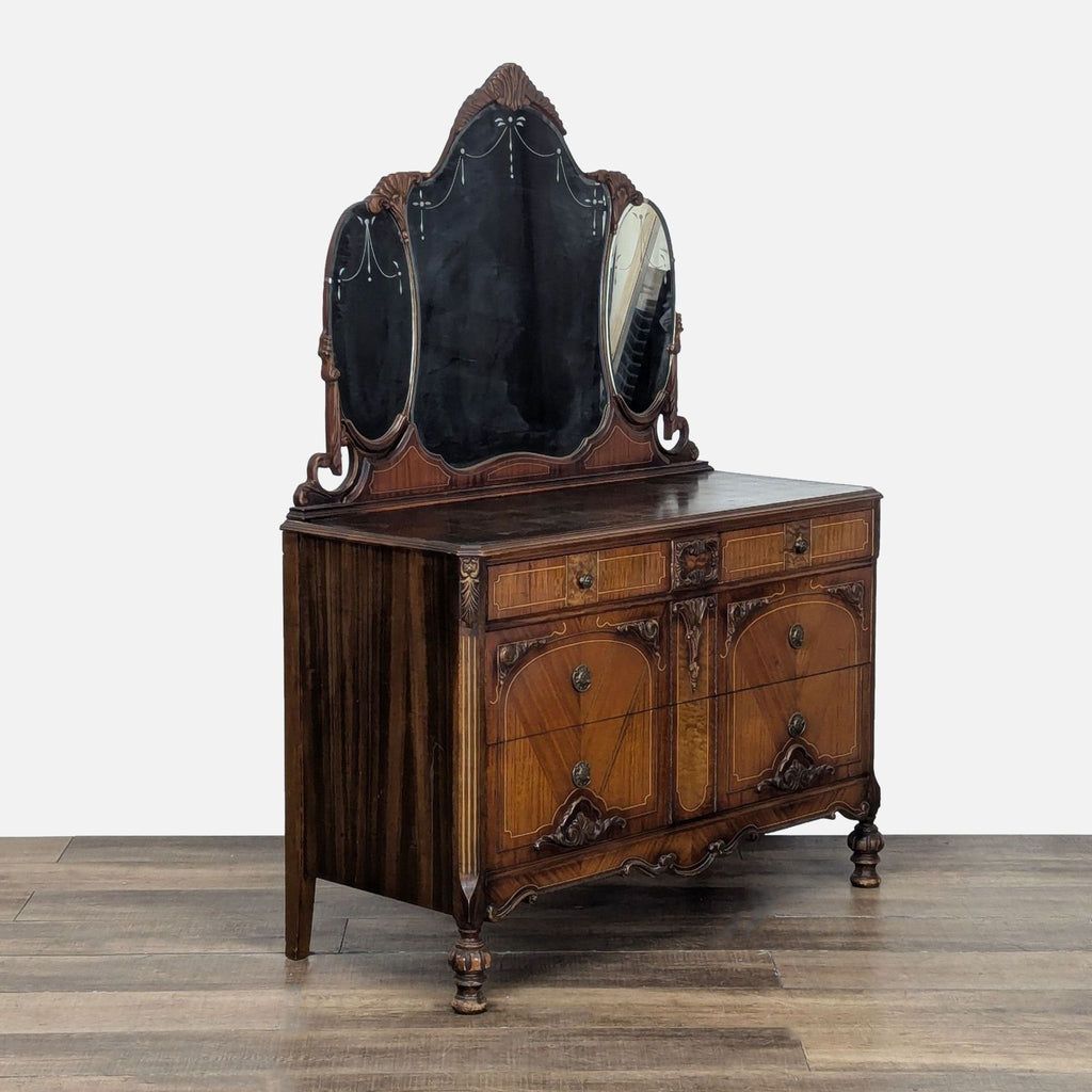 3. Angled shot of an antique wooden dresser by Reperch, featuring a three-panel mirror and intricate detailing.