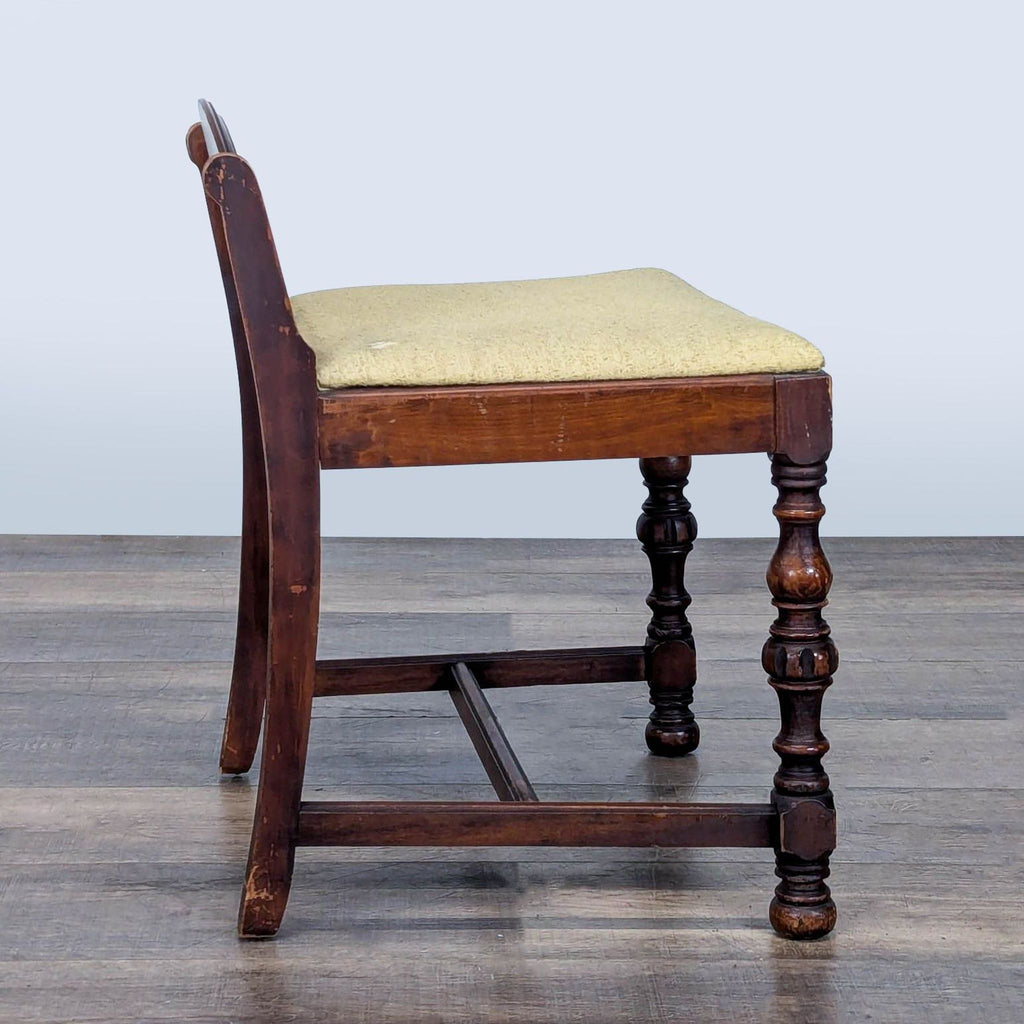 3. Profile view of Reperch bench featuring a beige upholstered seat, decorative legs, and a curved wooden backrest.