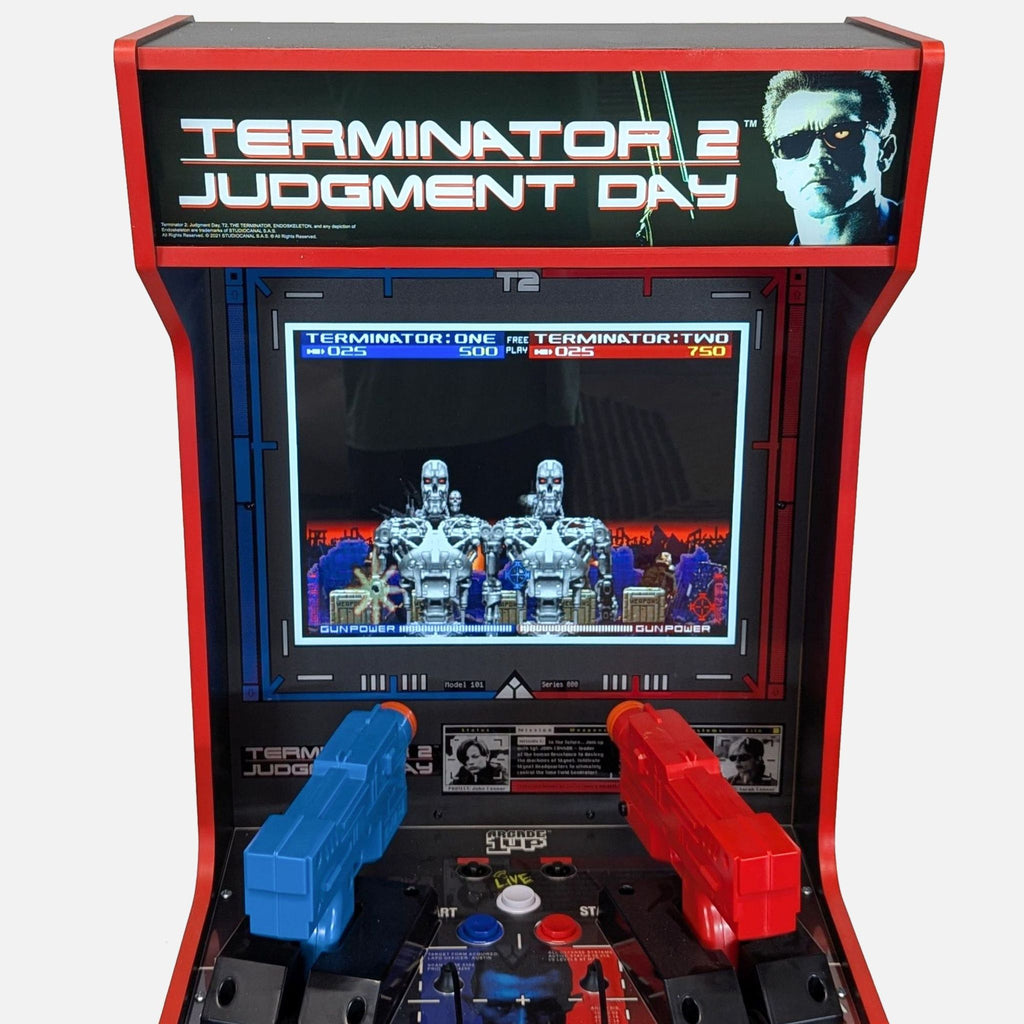 2. Close-up of Arcade1Up T2 arcade machine featuring classic shooter gameplay and two light gun controllers.  