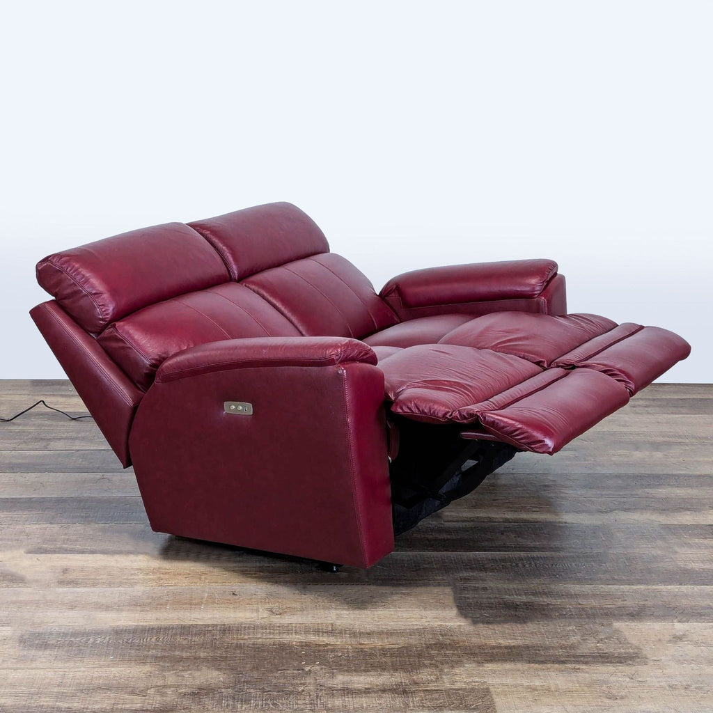 2. La-Z-Boy loveseat in maroon leather shown fully reclined, featuring power recline and lumbar comfort.