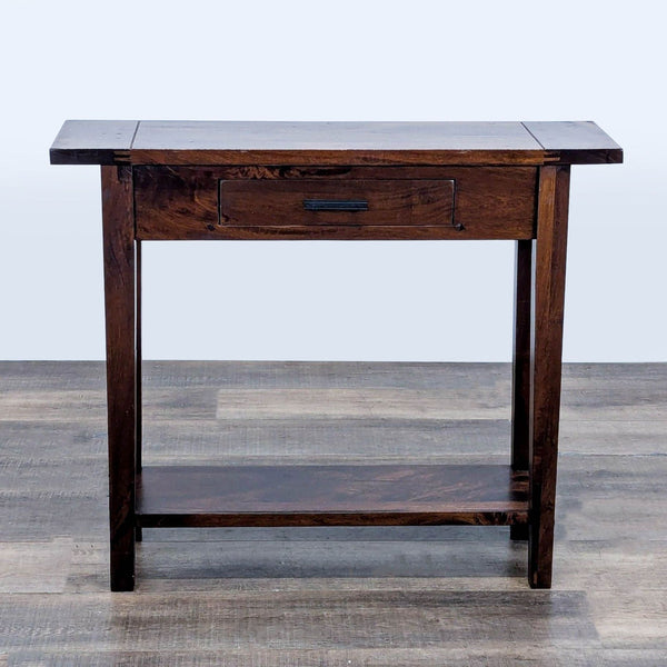1. Cost Plus World Market side table in dark wood with a drawer and lower shelf, shown on a wood floor.