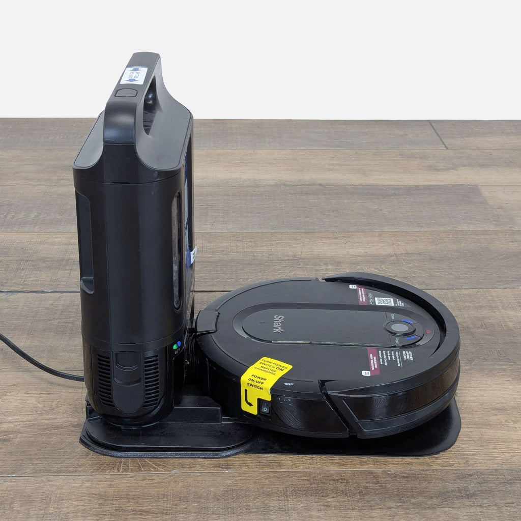 3. Shark robot vacuum docked at its base station, side angle highlighting its compact, modern design.
