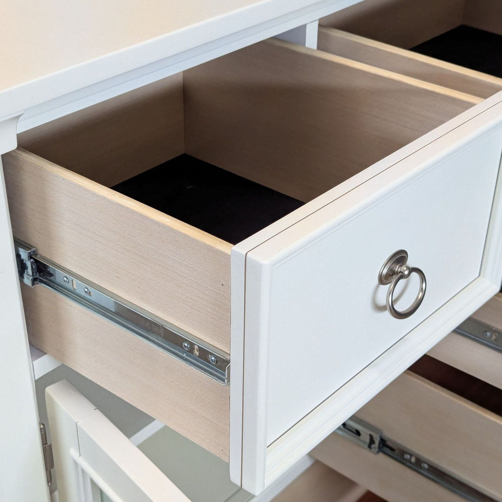 3. Close-up of an open drawer on the Ashley white dresser, showing interior and cabinet hardware detail.