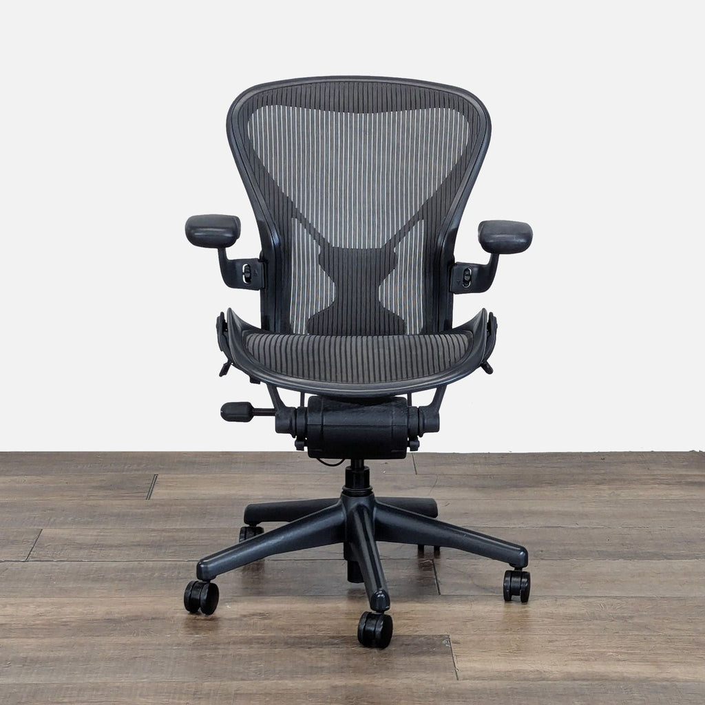 1. Front view of a Herman Miller office chair featuring 8Z Pellicle mesh and adjustable PostureFit SL lumbar support.  