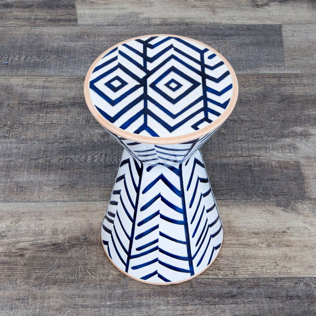 2. Top-down view of Anthropologie ceramic end table, showcasing bold chevron and diamond navy patterns.