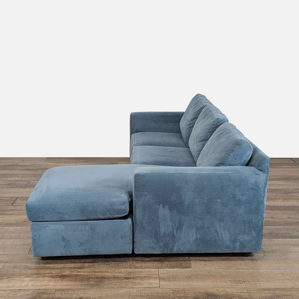 3. Sectional from Crate and Barrel in blue, featuring track arms and a spacious chaise with built-in storage.