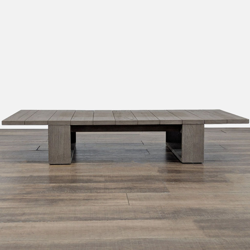 1. Low, modern table with a slatted teak top and open rectangular base, shown in a room setting.  