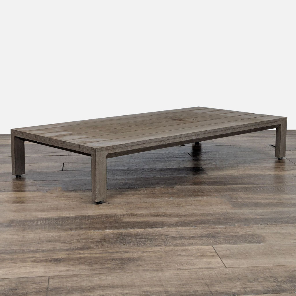 3. Restoration Hardware weathered teak table, low-profile design with slatted top, viewed at an angle.