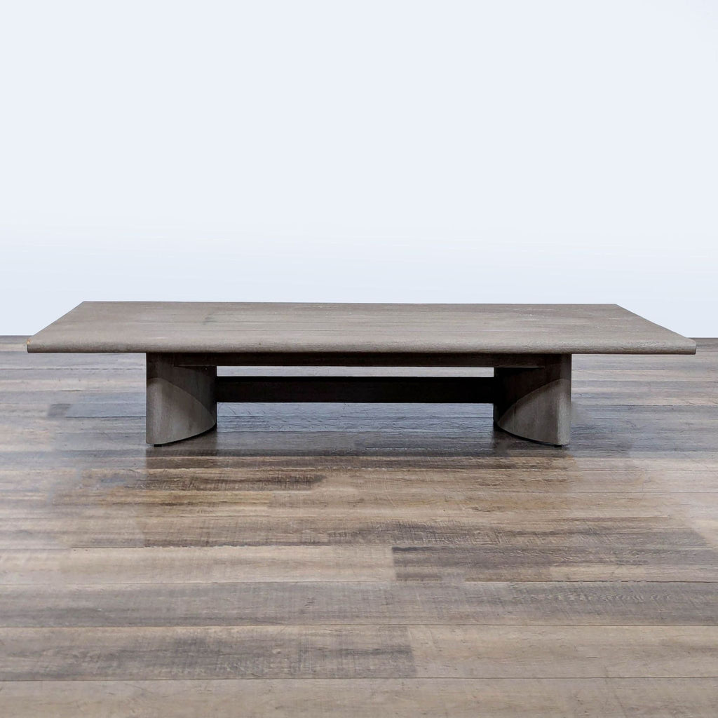3. Low-profile coffee table crafted of weathered teak, with artistic curved legs and minimalist slat design.