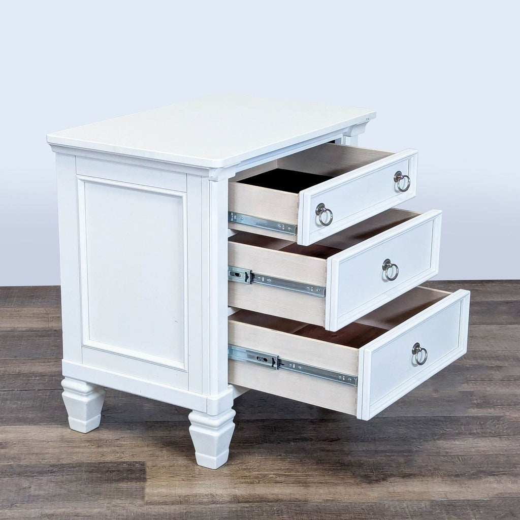 2. Side view of Ashley Furniture end table showing three smooth-operating drawers partially open on sturdy legs.