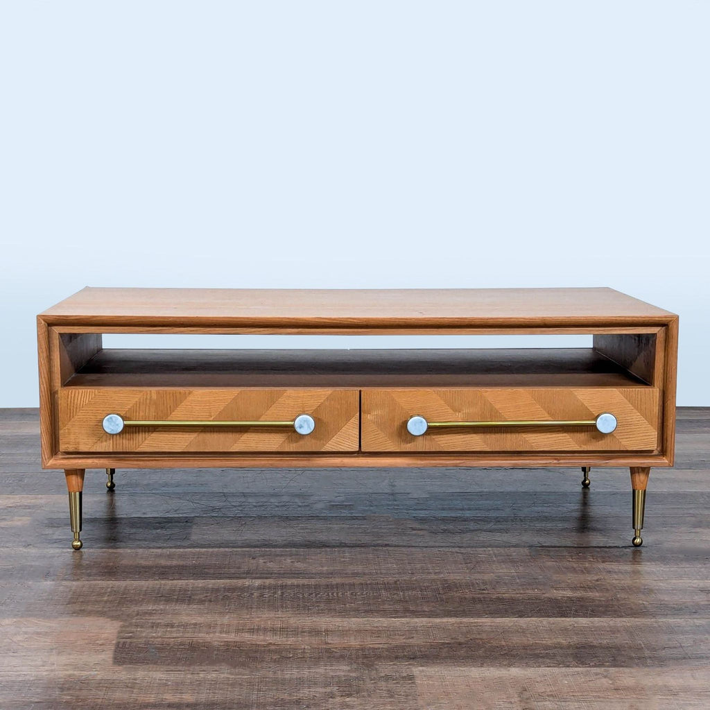 1. Rectangular Anthropologie coffee table with four inlaid drawers and metal hardware, shown from the front.