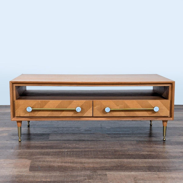 1. Rectangular Anthropologie coffee table with four inlaid drawers and metal hardware, shown from the front.