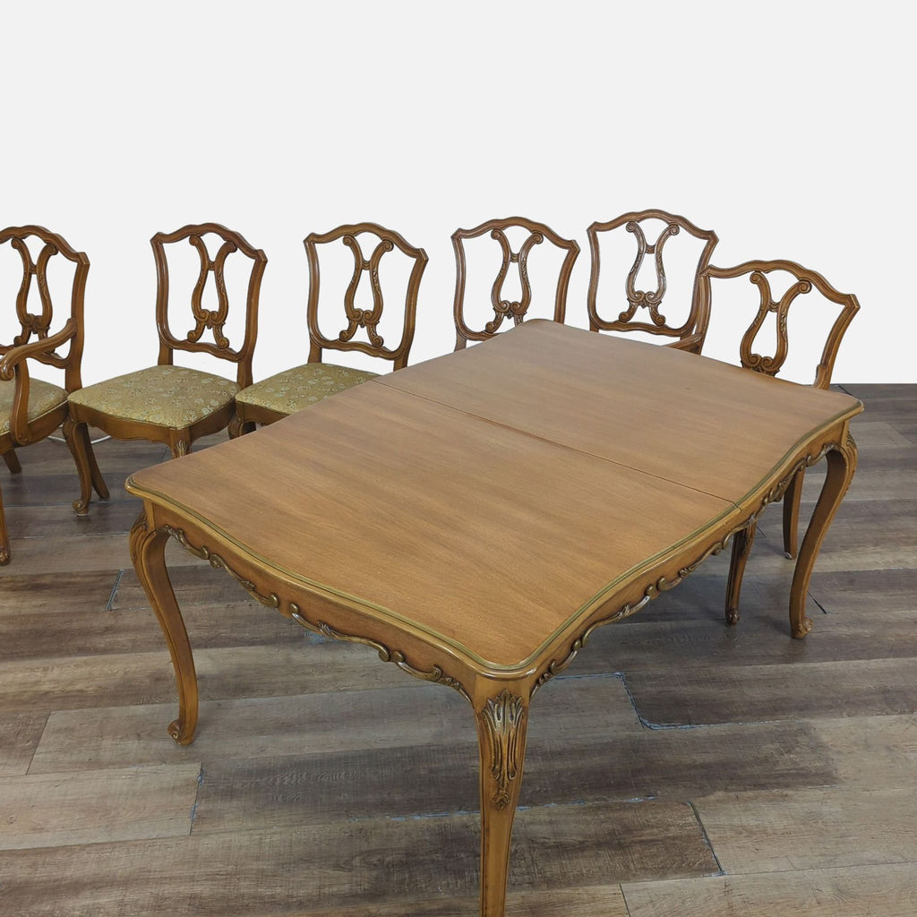 2. Elegant Reperch dining table and six chairs with ornate wood detailing and upholstered seats.