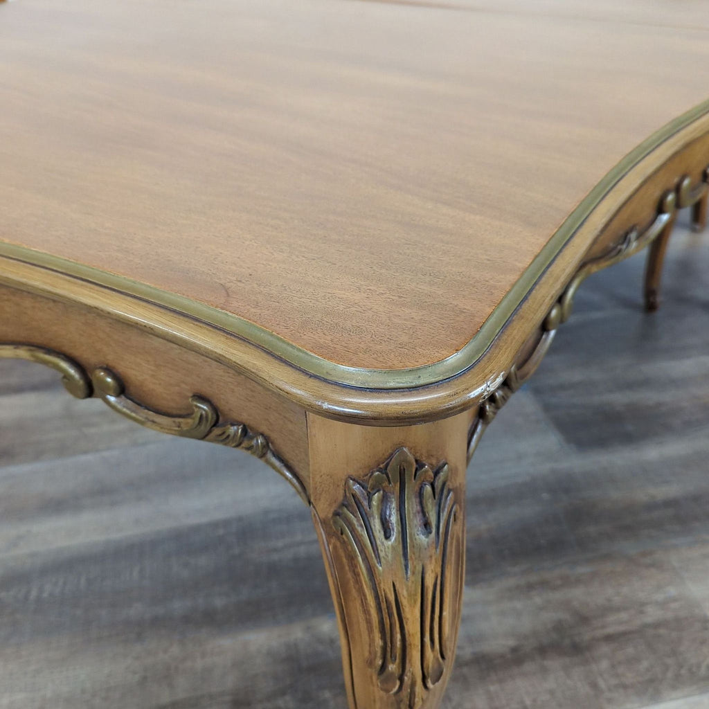 3. Closeup of the Reperch dining table's carved wood accent and smooth tabletop finish.