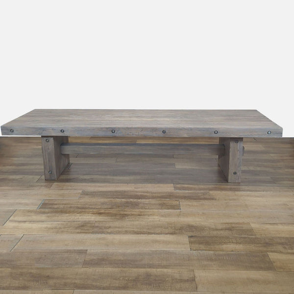 1. Large rectangular wooden dining table with industrial bolts, placed on matching wood flooring.