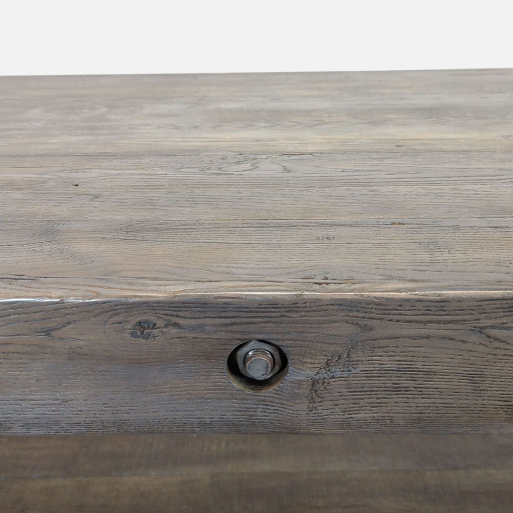 2. Close-up of the dining table’s wood grain and metal bolt detail on the tabletop edge.