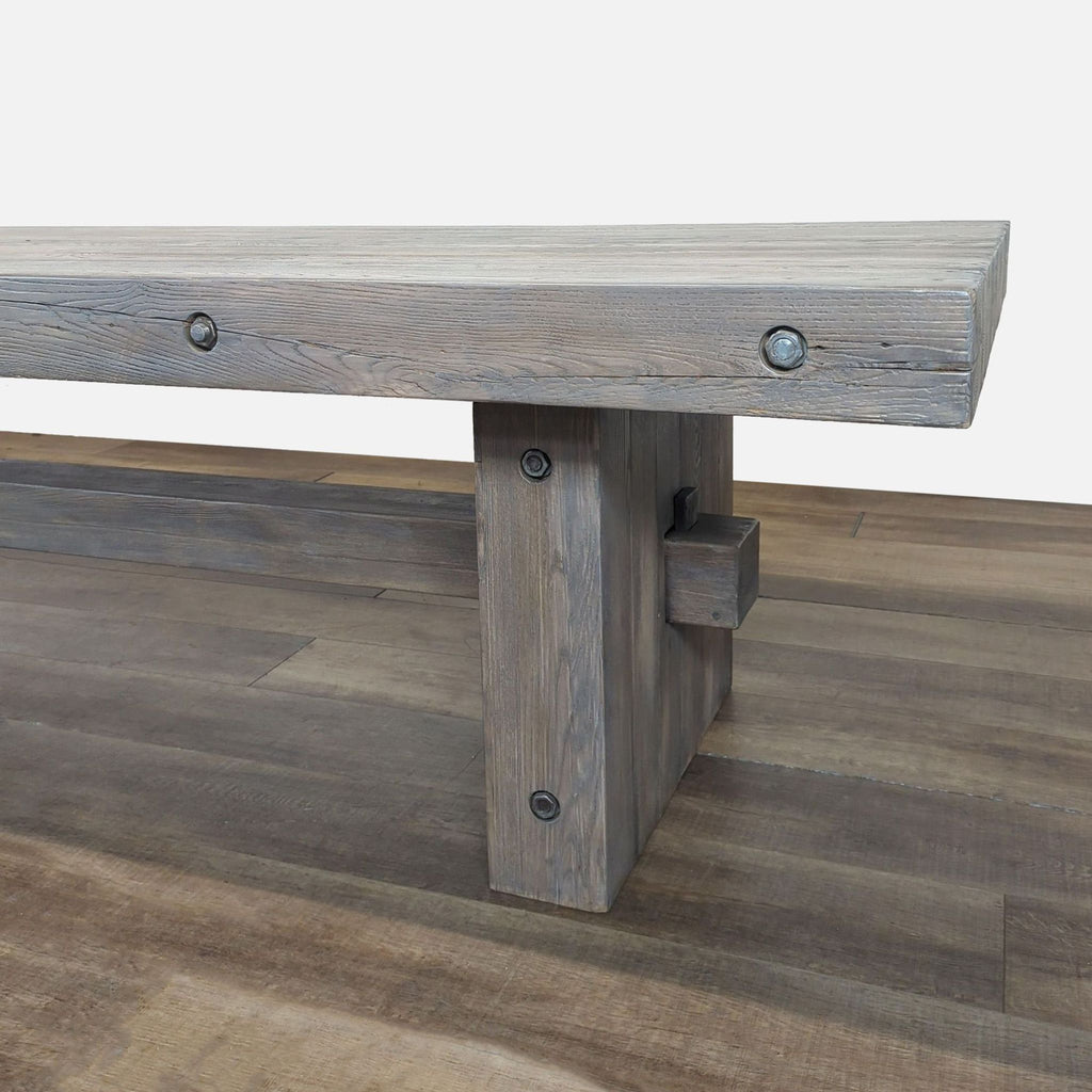 3. Angled view showing the table’s sturdy leg construction and bolted joinery, highlighting the rustic finish.