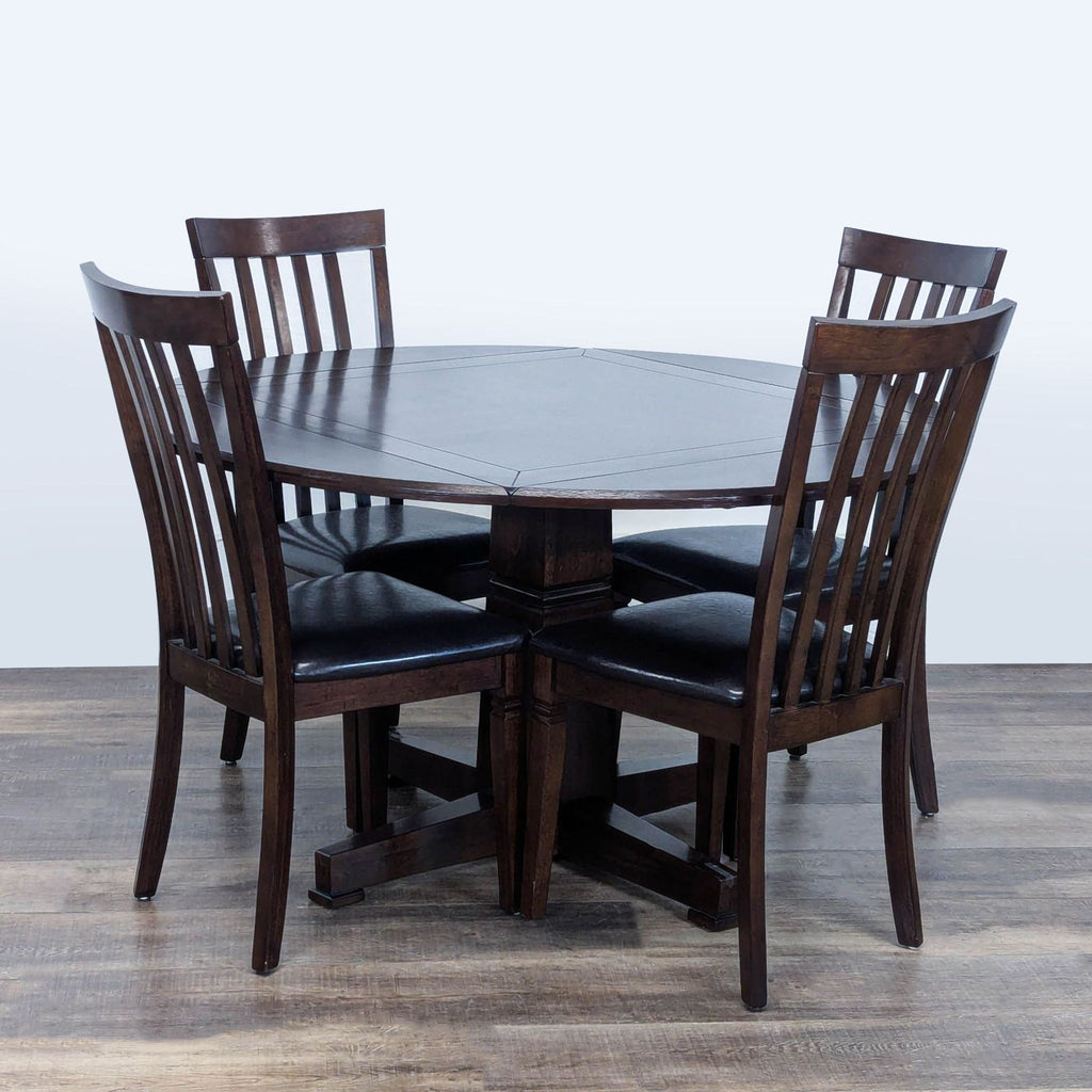 3. Dining set with a round drop leaf table and four matching slat back, leather seat chairs, by Rooms To Go.
