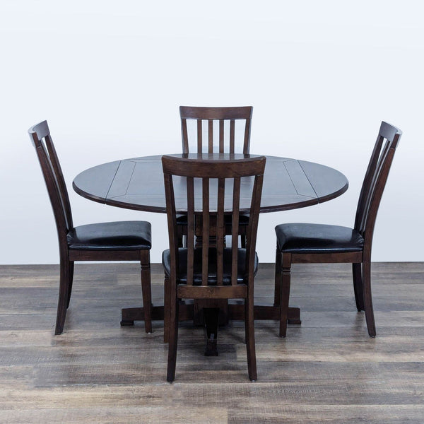 1. Dark wood round dining table with four drop leafs and four slat back chairs with black leather seats.  